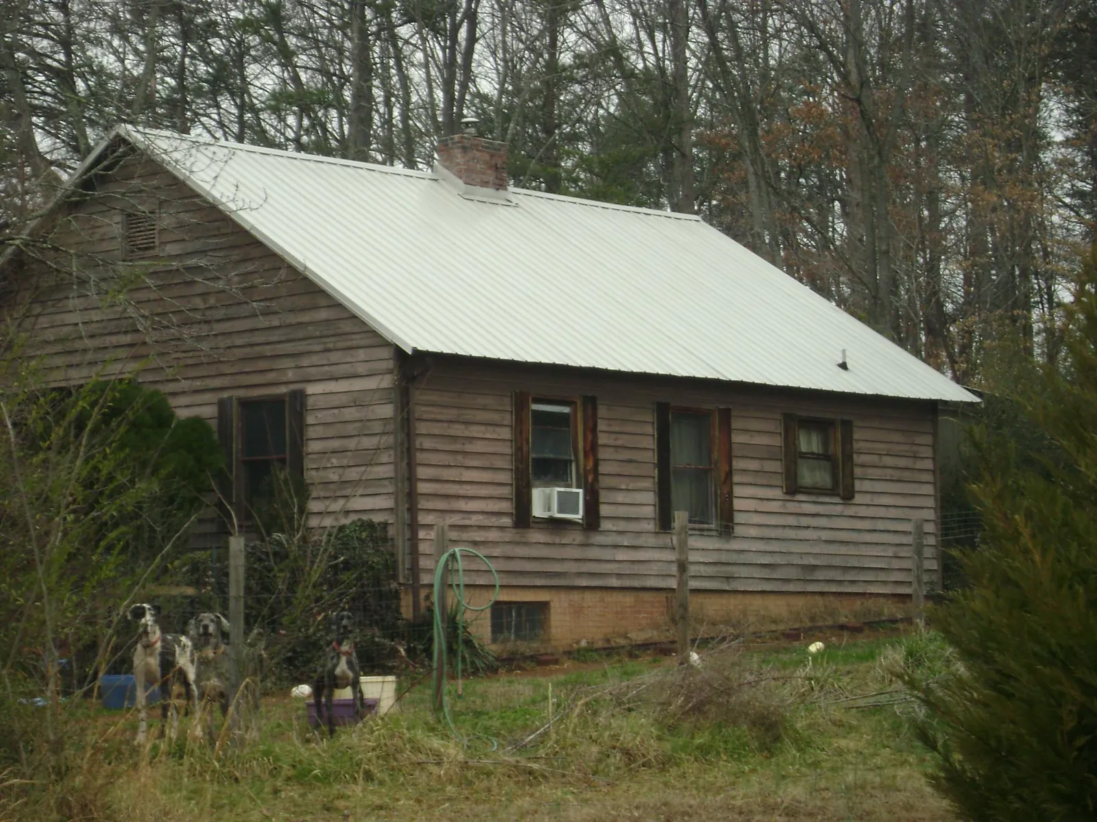 White metal roof on an old wood sided farmhouse, from a Metal Roof Installation job in Allport